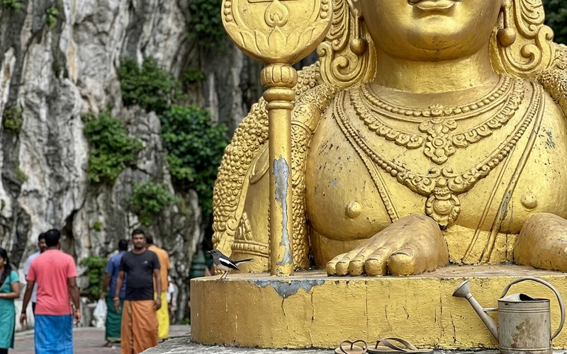 Close detail of the Lord Murugan statue holding the Vel
