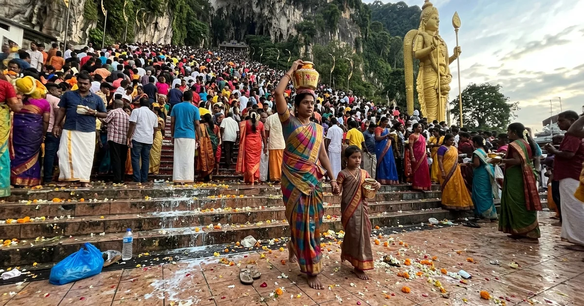 A vast Thaipusam crowd filling the Batu Caves staircase and forecourt at dawn