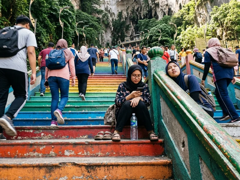 The rainbow-painted 272 steps at Batu Caves with visitors climbing